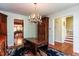Elegant dining room with stylish furniture, chandelier, and access to stairs at 3005 Woodgreen Dr, Raleigh, NC 27607