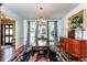 Traditional dining room featuring wood floors, ornate chandelier and large windows at 3005 Woodgreen Dr, Raleigh, NC 27607