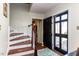 Inviting entryway featuring staircase, stylish rug, and view to exterior at 3005 Woodgreen Dr, Raleigh, NC 27607