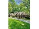 Charming brick home featuring a lush green lawn and mature trees at 3005 Woodgreen Dr, Raleigh, NC 27607