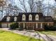 Lovely brick home with dormer windows and a well-maintained front yard at 3005 Woodgreen Dr, Raleigh, NC 27607