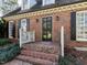 Close-up of the front door, brick facade, and traditional accents at 3005 Woodgreen Dr, Raleigh, NC 27607