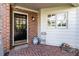 Charming front porch with brick flooring, stylish door and white accents at 3005 Woodgreen Dr, Raleigh, NC 27607