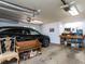 Organized garage with workspace, car, and seating, offering both functionality and storage at 3005 Woodgreen Dr, Raleigh, NC 27607