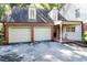 Spacious two car garage with driveway, stylish windows and covered porch at 3005 Woodgreen Dr, Raleigh, NC 27607