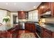 Stylish kitchen with cherry cabinets, granite counters, and stainless steel appliances at 3005 Woodgreen Dr, Raleigh, NC 27607