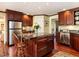 Elegant kitchen with a central island, custom cabinetry, and stainless steel refrigerator at 3005 Woodgreen Dr, Raleigh, NC 27607