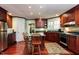 Charming kitchen with cherry cabinets, an island with seating, and stainless steel appliances at 3005 Woodgreen Dr, Raleigh, NC 27607