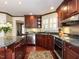 Gourmet kitchen with granite countertops, stainless steel appliances, and custom cabinetry at 3005 Woodgreen Dr, Raleigh, NC 27607