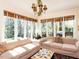 Sunlit living room with comfortable sofas and large windows overlooking the trees at 3005 Woodgreen Dr, Raleigh, NC 27607