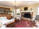 Bright living room showcasing a brick fireplace and hardwood flooring at 3005 Woodgreen Dr, Raleigh, NC 27607