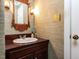 Elegant powder room featuring textured wallpaper, ornate mirror, and classic fixtures at 3005 Woodgreen Dr, Raleigh, NC 27607