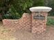 Charming brick signage at the entrance of the 'Woodgreen' community, set amidst lush greenery at 3005 Woodgreen Dr, Raleigh, NC 27607