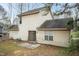 View of the back of the house featuring a sliding glass door, window, and some yard space at 3323 Nantuckett Ave, Durham, NC 27703