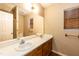 Bathroom featuring dual sinks, large mirror, and wood-look flooring at 3323 Nantuckett Ave, Durham, NC 27703