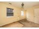 Bedroom features two windows for natural light, ceiling fan, with visible wear and tear at 3323 Nantuckett Ave, Durham, NC 27703