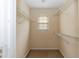 Walk-in closet featuring wire shelving and a window, providing storage and natural light at 3323 Nantuckett Ave, Durham, NC 27703