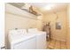 Functional laundry room featuring white washer and dryer appliances, and wire shelving at 3323 Nantuckett Ave, Durham, NC 27703