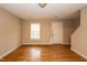 Inviting living room with natural light from the window and hardwood flooring at 3323 Nantuckett Ave, Durham, NC 27703