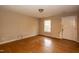 Bright living room with hardwood floors, a window, and a front door at 3323 Nantuckett Ave, Durham, NC 27703