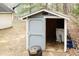 Backyard shed with open door showing washer and dryer hookups, offering extra storage space at 3323 Nantuckett Ave, Durham, NC 27703