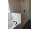 Modern white tiled bathroom featuring a luxurious soaking tub and walk-in shower with black hardware at 358 Coats Ridge Dr, Benson, NC 27504