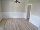 An empty dining room features decorative chair rail and ample natural light at 358 Coats Ridge Dr, Benson, NC 27504