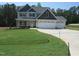 Charming two-story home features a three-car garage and a well-manicured lawn at 358 Coats Ridge Dr, Benson, NC 27504