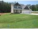 Charming two-story home features a three-car garage and a well-manicured lawn at 358 Coats Ridge Dr, Benson, NC 27504