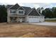 Inviting two-story home with a three-car garage and a welcoming front porch, perfect for relaxing evenings at 358 Coats Ridge Dr, Benson, NC 27504