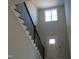 Bright foyer featuring staircase with black metal railing and a window for natural light at 358 Coats Ridge Dr, Benson, NC 27504