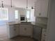 Bright kitchen featuring granite counters, a stainless steel sink, and modern white cabinets at 358 Coats Ridge Dr, Benson, NC 27504