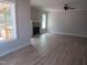 Open-concept living room with fireplace and large windows providing outdoor views and natural light at 358 Coats Ridge Dr, Benson, NC 27504