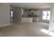 Open-concept living room leading to a spacious kitchen with white cabinets and an island at 358 Coats Ridge Dr, Benson, NC 27504