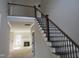 Elegant staircase with wooden handrails and black iron balusters, bathed in natural light, ready for personalization at 358 Coats Ridge Dr, Benson, NC 27504