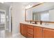 Bathroom featuring dual vanities, a large mirror, and a separate toilet room at 3910 Wedonia Dr, Cary, NC 27519