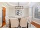 Elegant dining room featuring tray ceilings, modern lighting, and a dining table with seating for six at 3910 Wedonia Dr, Cary, NC 27519