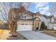 Charming two-story home featuring a stone-accented entrance, attached two-car garage, and well-maintained landscaping at 3910 Wedonia Dr, Cary, NC 27519