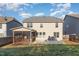 View of the back of the house from the yard with screened in porch and patio at 3910 Wedonia Dr, Cary, NC 27519