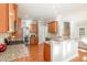 Spacious kitchen featuring wood cabinets, granite countertops, and stainless steel appliances, perfect for cooking at 3910 Wedonia Dr, Cary, NC 27519