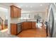 Well-lit kitchen with hardwood floors, wood cabinets, stainless steel appliances, and a view to the dining area at 3910 Wedonia Dr, Cary, NC 27519