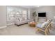 Comfortable living room featuring a sofa, chair, coffee table, and large windows at 3910 Wedonia Dr, Cary, NC 27519