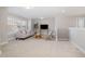 Bright living room with neutral tones, carpeted floors, and large windows at 3910 Wedonia Dr, Cary, NC 27519