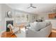 Cozy living room featuring hardwood floors, a fireplace, and comfortable seating, great for Gathering gatherings at 3910 Wedonia Dr, Cary, NC 27519