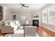 Bright living room with hardwood floors, fireplace, and neutral decor, perfect for relaxation and entertaining at 3910 Wedonia Dr, Cary, NC 27519