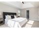 Bright primary bedroom features a king bed, bedside tables, and a tray ceiling at 3910 Wedonia Dr, Cary, NC 27519