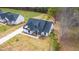 Charming new home with a black roof and white exterior, surrounded by a spacious yard and mature trees at 4017 Mebane Oaks Rd, Mebane, NC 27302