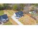 New home featuring a black roof and white exterior with a long driveway, surrounded by a spacious yard at 4017 Mebane Oaks Rd, Mebane, NC 27302
