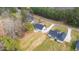 Aerial view of modern homes in a neighborhood surrounded by mature trees and open land at 4017 Mebane Oaks Rd, Mebane, NC 27302