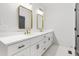 Primary bathroom with a dual sink vanity featuring white cabinets and black hardware at 4017 Mebane Oaks Rd, Mebane, NC 27302
